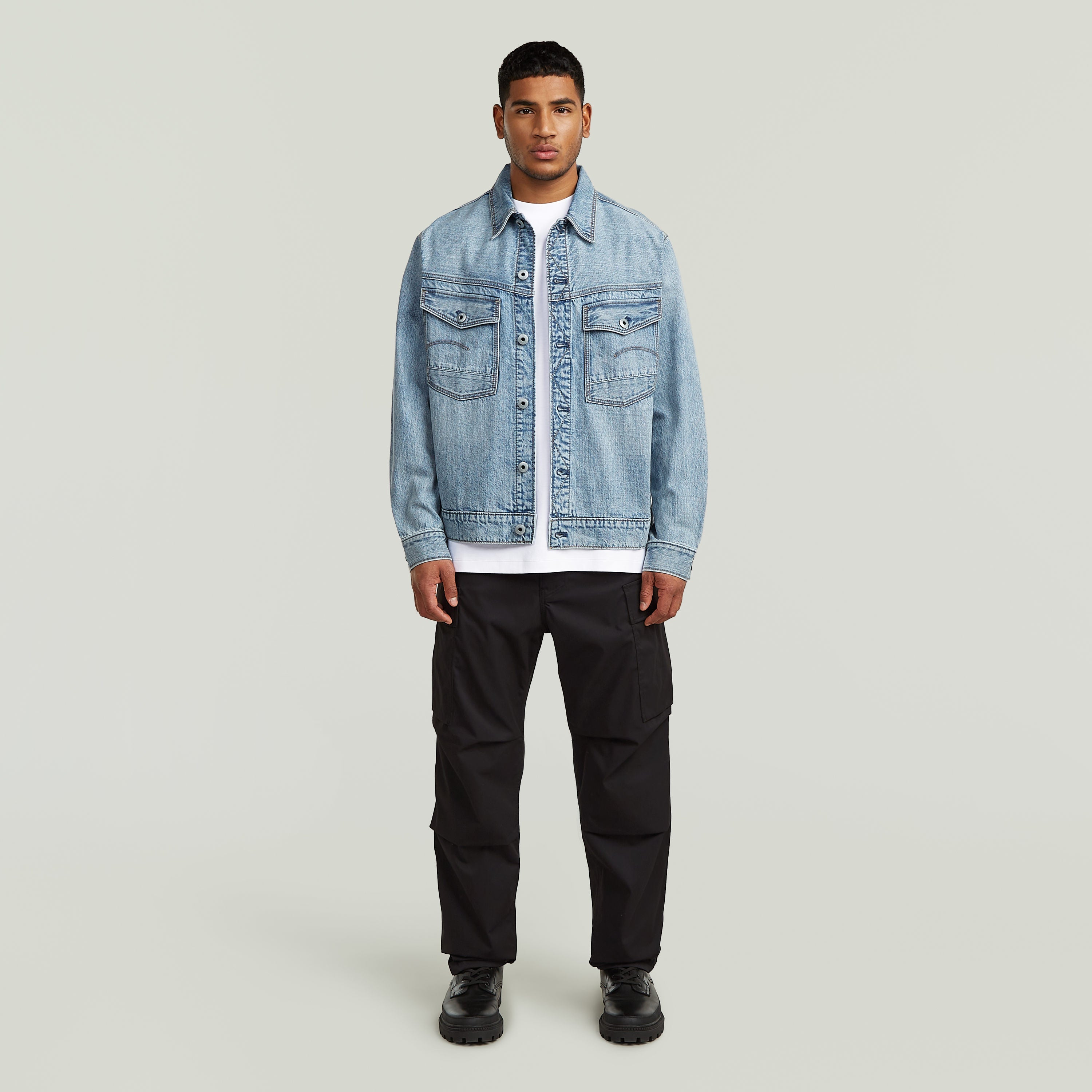 Modelo masculino usando la chaqueta denim Dakota con corte recto, botones y bolsillos en el pecho y cintura.