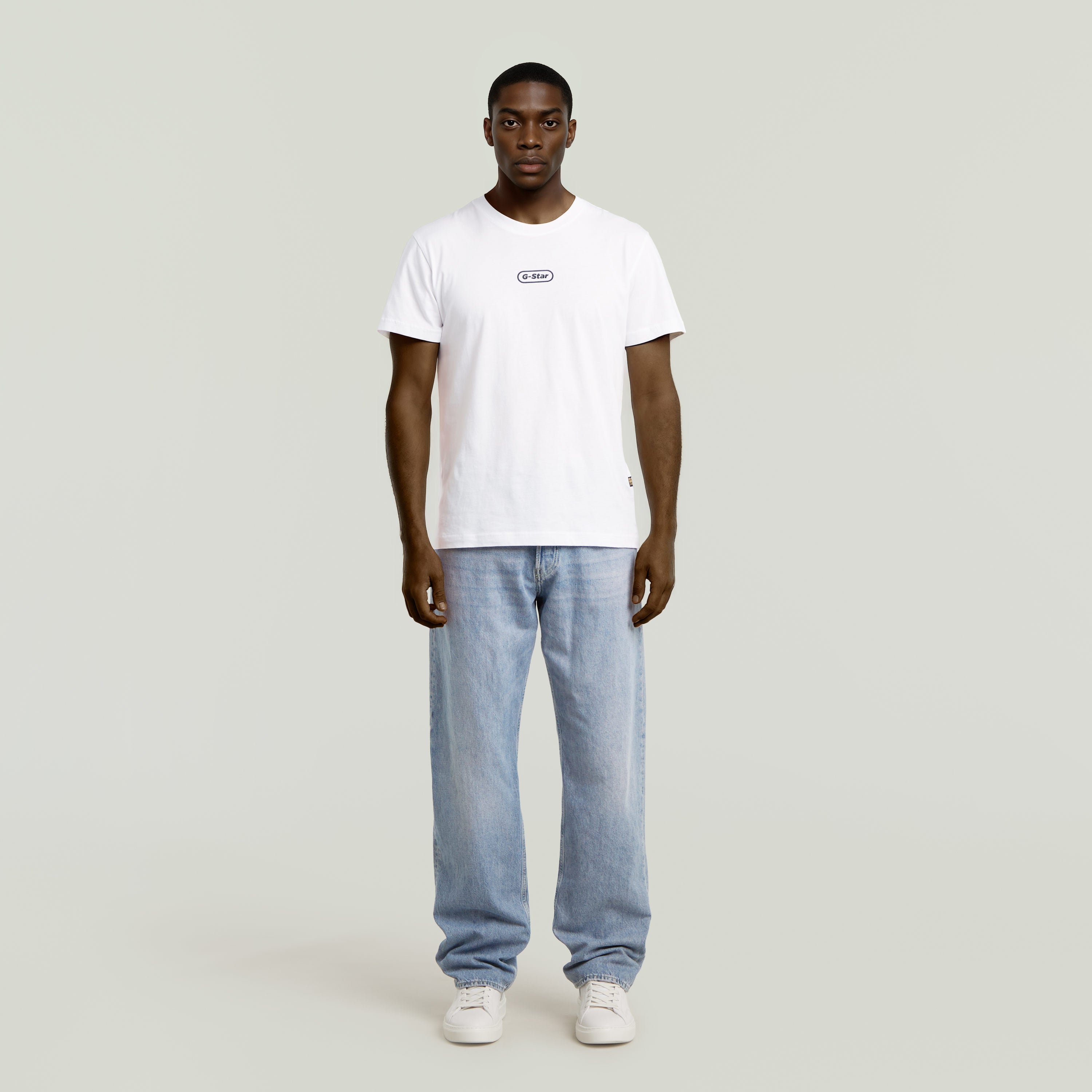 Hombre vistiendo jeans Dakota Regular Straight con camiseta blanca, mostrando un estilo relajado y moderno.