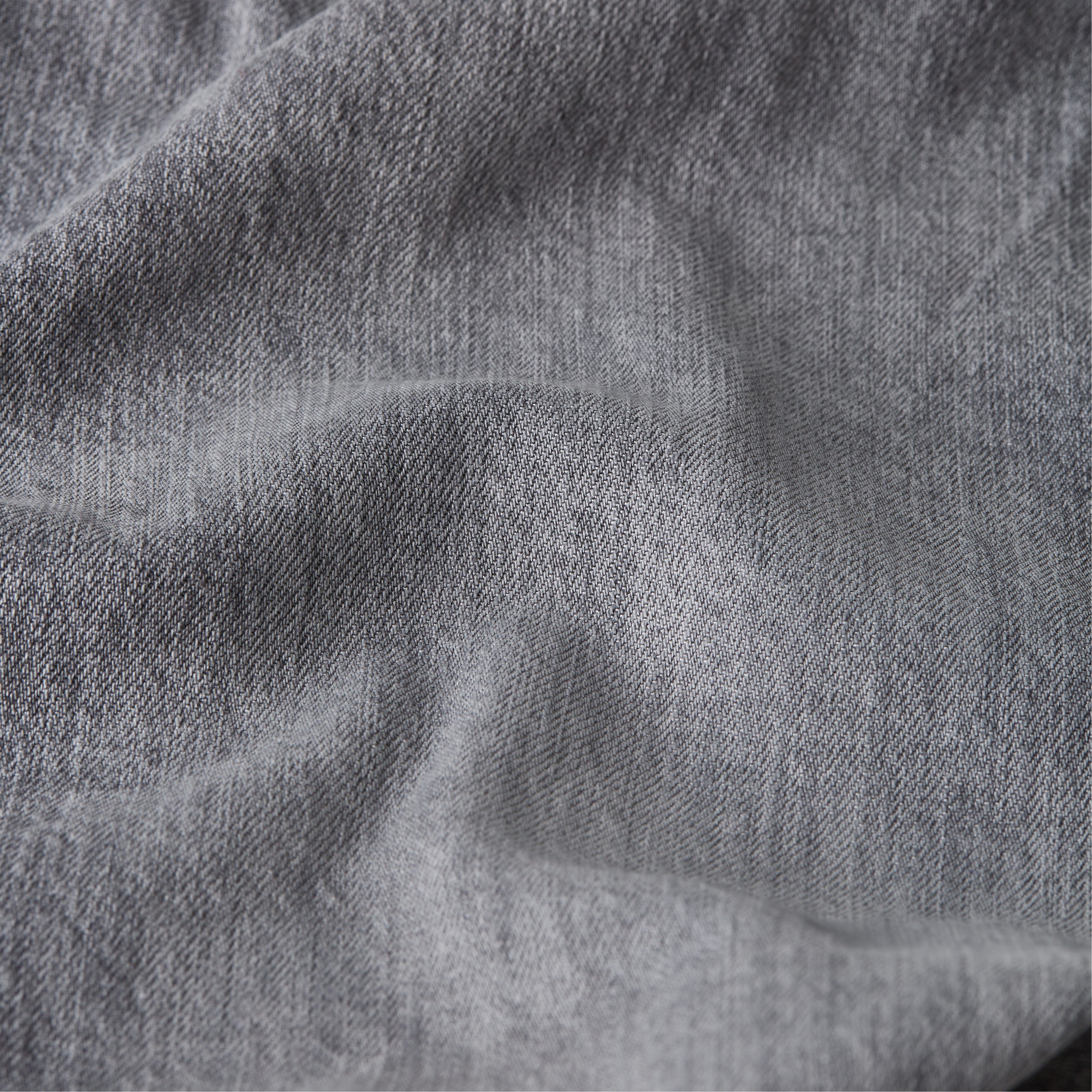 Close-up view of denim fabric texture for Mosa straight jeans.