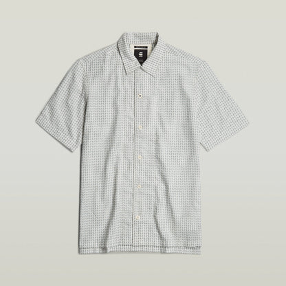 Camisa Resort de corte recto con diseño de cuello plano y aberturas laterales, fabricada en algodón.