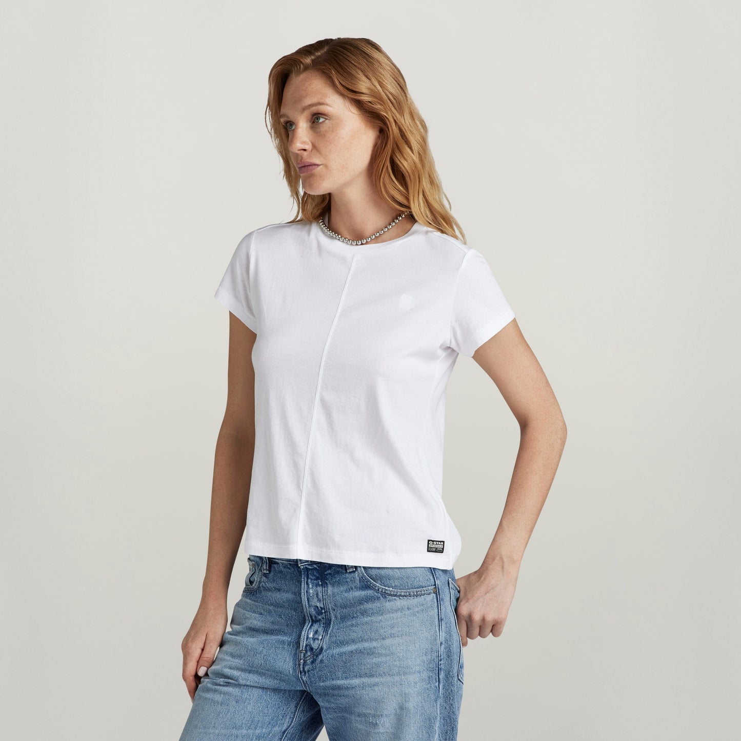 Top front seam shirt with embroidery worn by model, featuring front seam and ribbed collar.