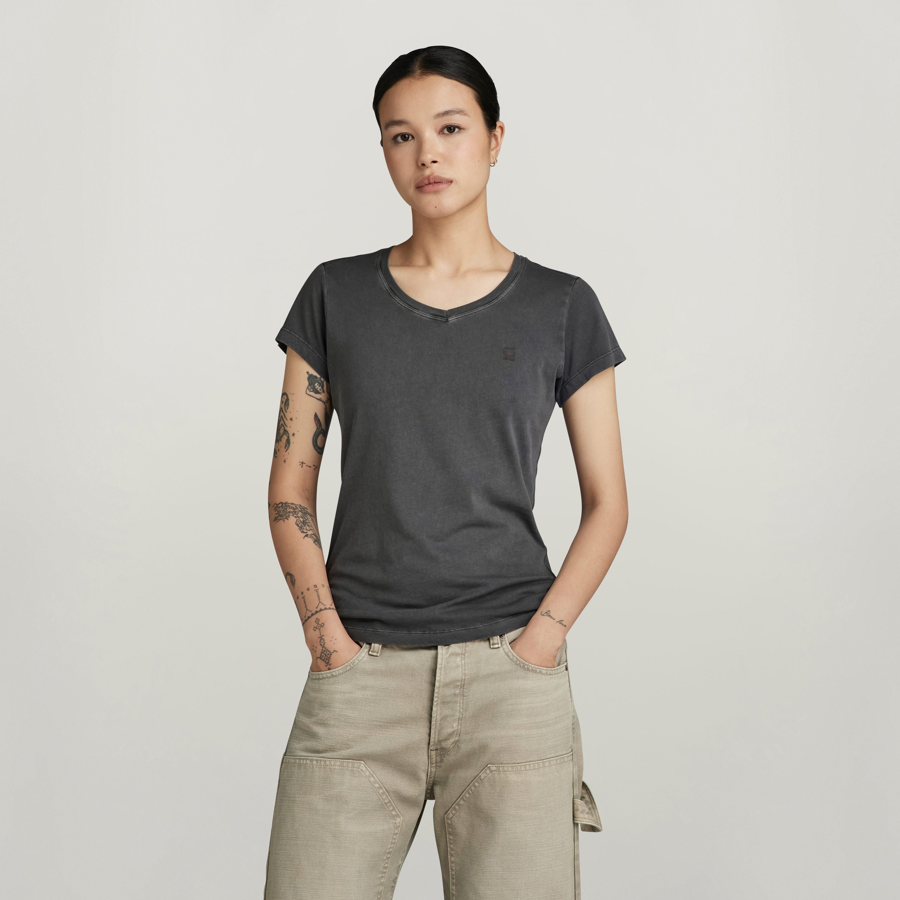 Imagen de mujer usando una camiseta de algodón orgánico con cuello V, cómoda y de manga corta, de G-Star RAW.
