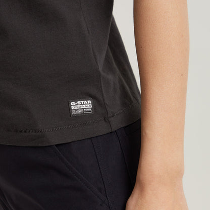 Faux embroidered logo top close-up showing G-Star Originals label on dark black fabric.