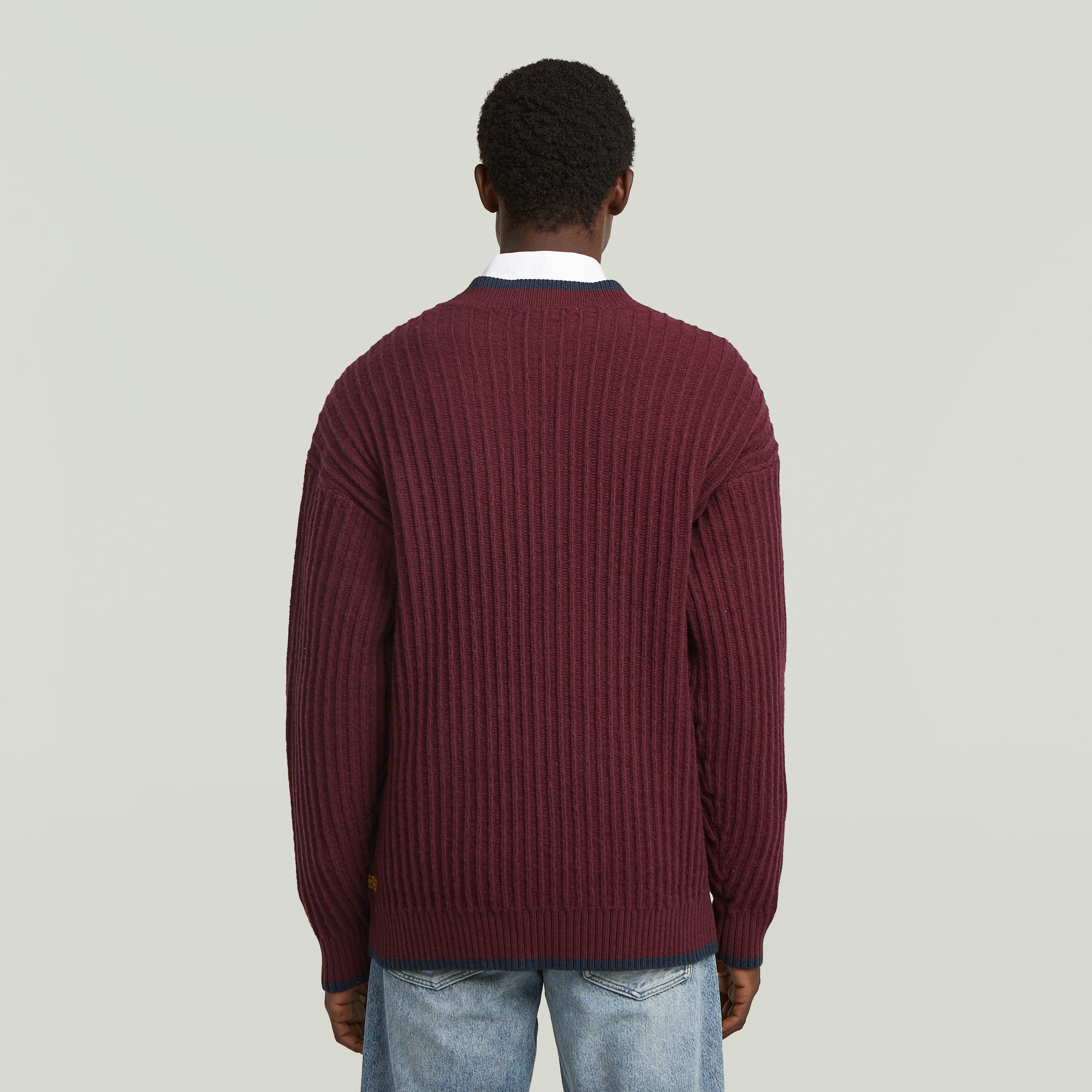 men's V-neck cardigan knit in a burgundy ribbed design, viewed from the back.