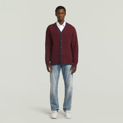 men's V-neck cardigan knit worn by a model in burgundy color with a casual outfit.