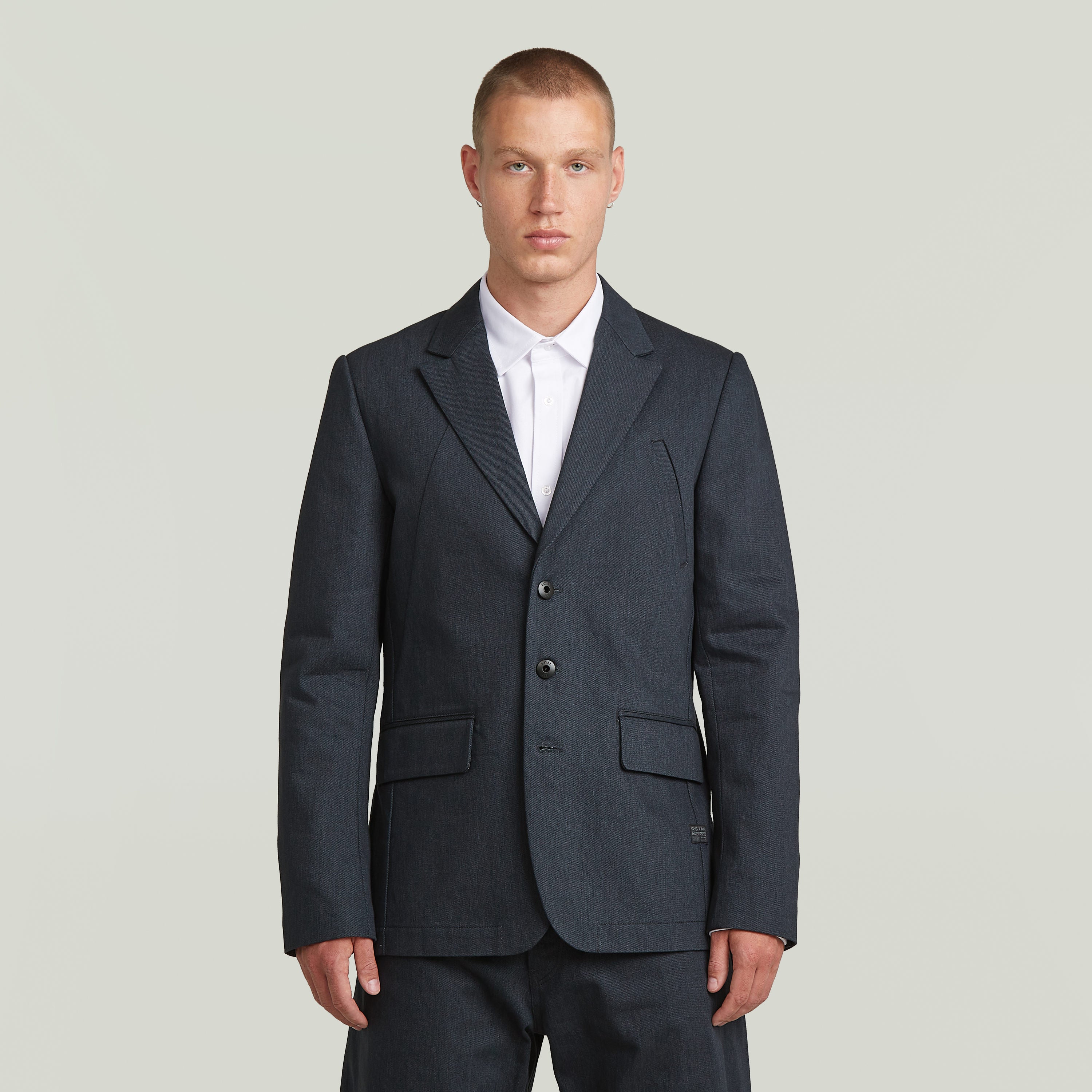 A-Line tailored denim blazer worn by a model in dark blue denim with a classic button closure.
