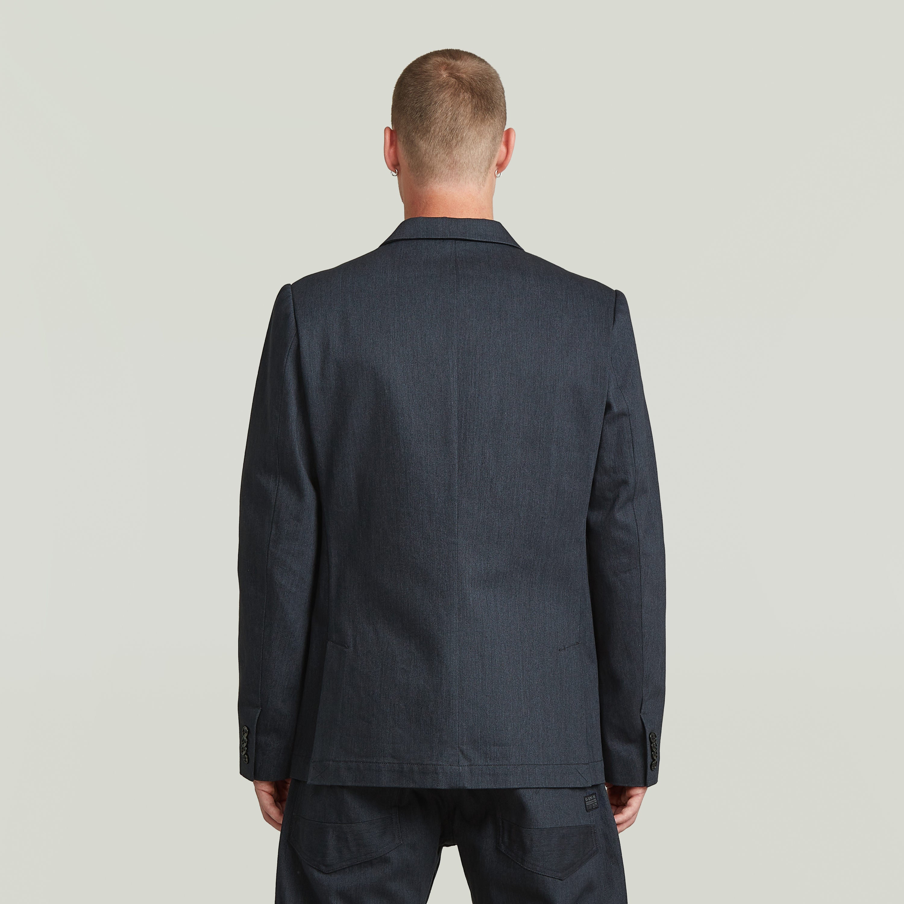 Back view of A-Line tailored denim blazer in dark blue, showcasing structured silhouette and premium Japanese denim.