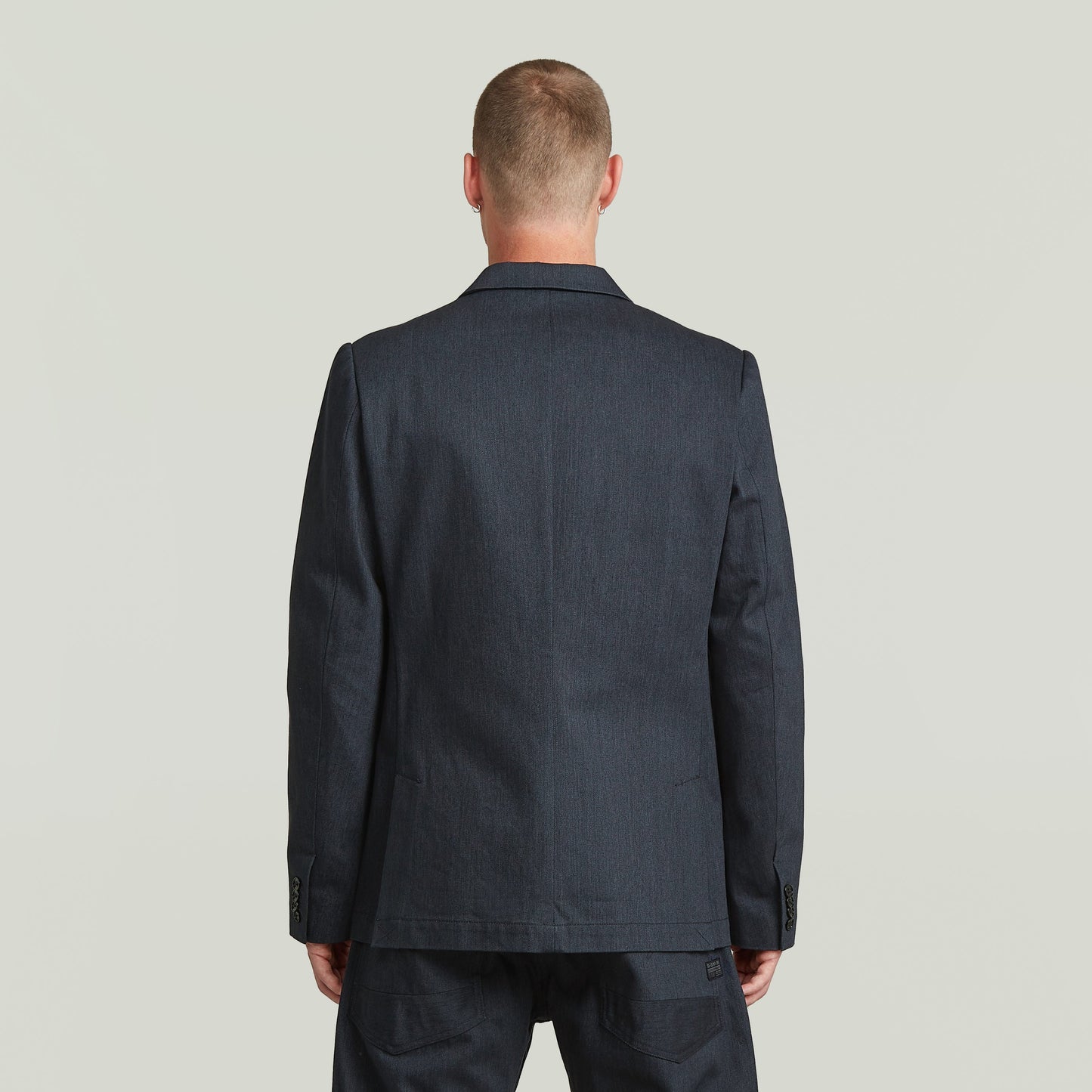 Back view of A-Line tailored denim blazer in dark blue, showcasing structured silhouette and premium Japanese denim.