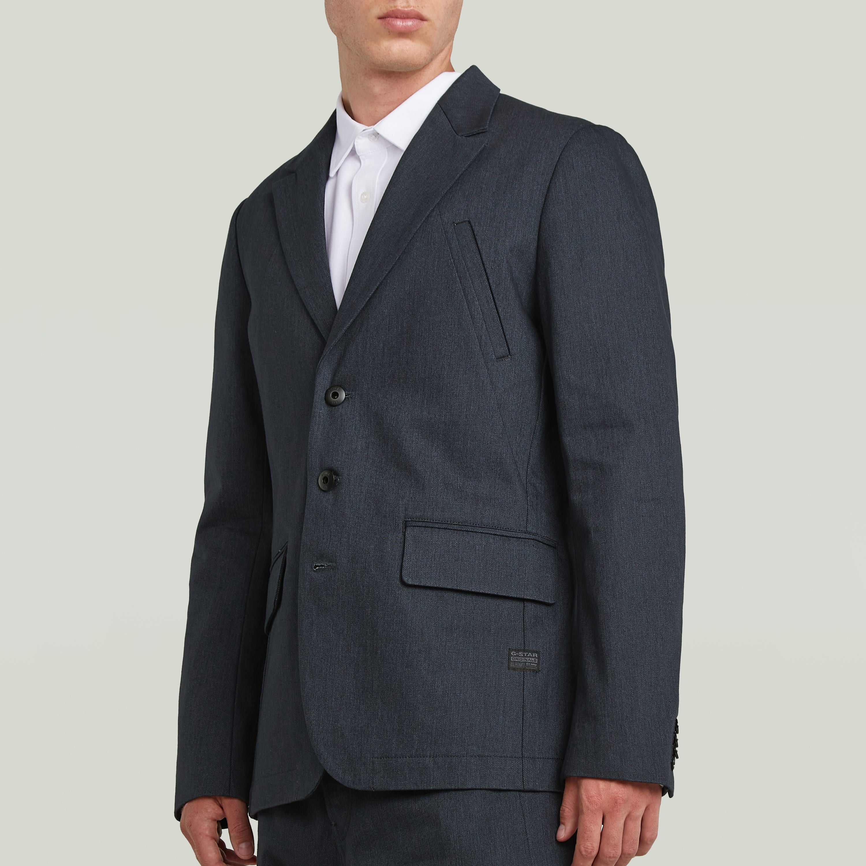 A-Line tailored denim blazer in dark blue, featuring a structured silhouette and classic button closure.