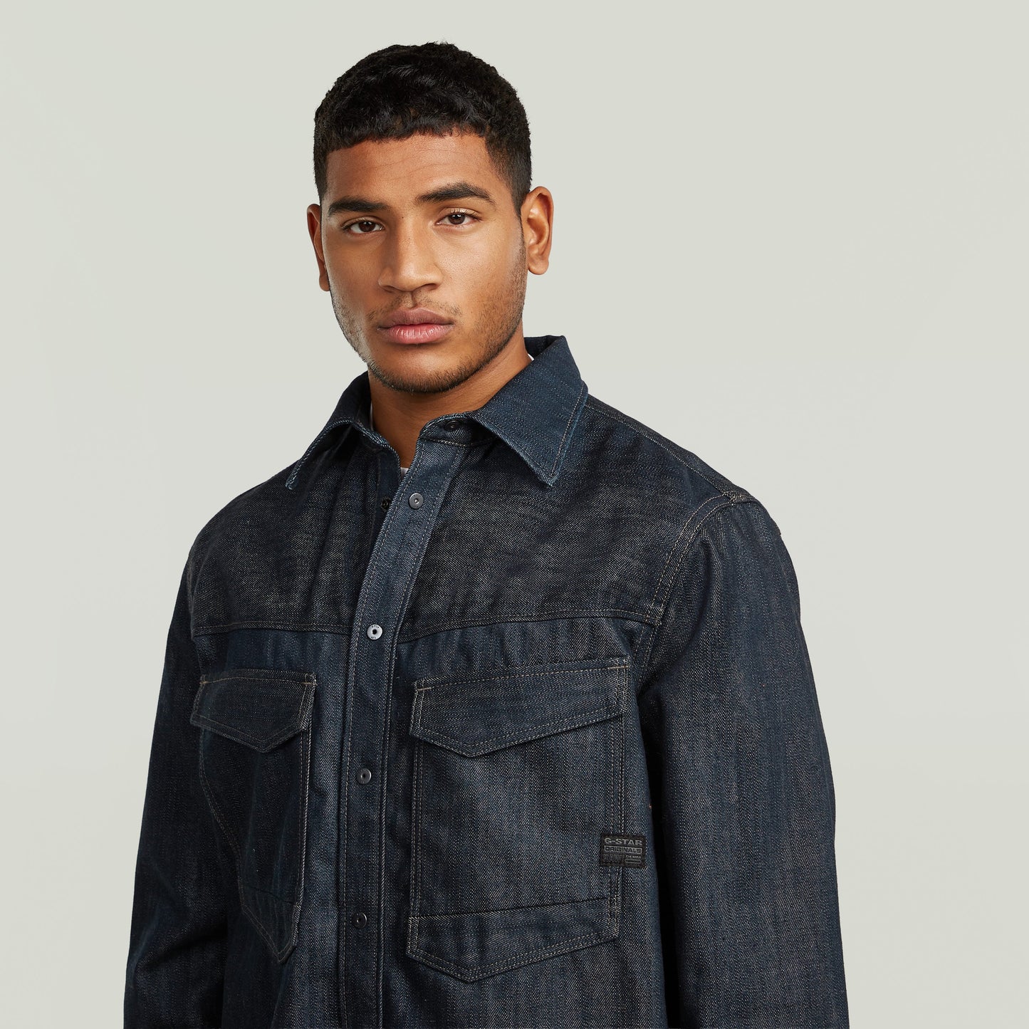 Sobrecamisa regular Dakota en denim greencast, con cuello de camisa y cierre de botones a presión, modelo masculino.