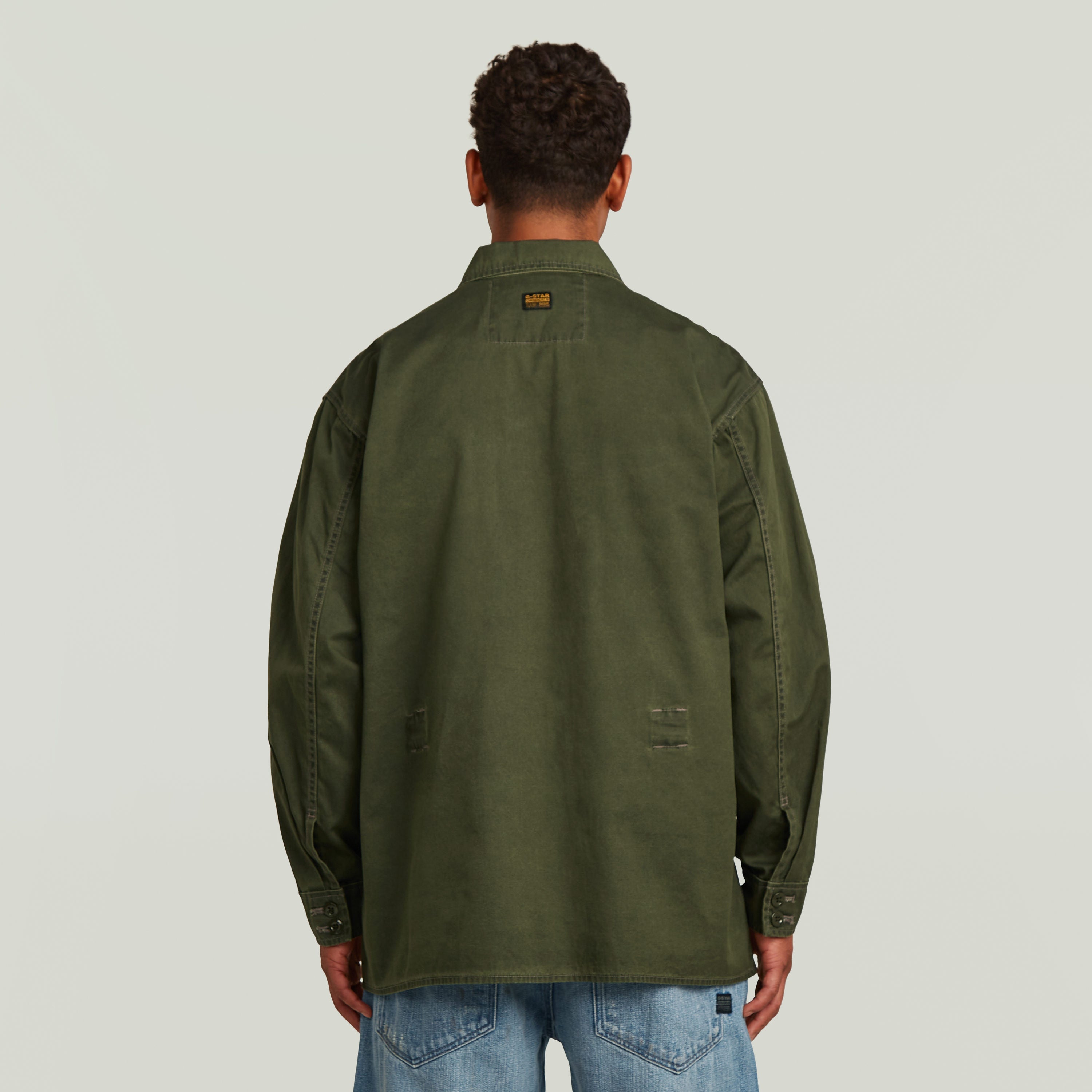 Reversible overshirt for versatile style in modern oversize fit and green color, showcasing back design.