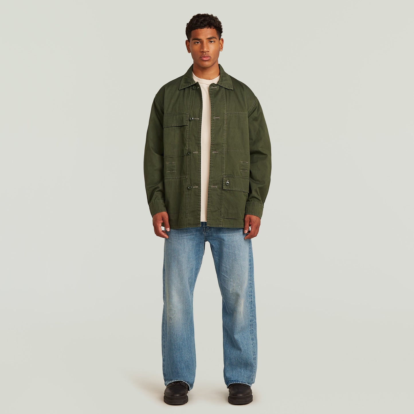 Reversible overshirt for versatile style, modern oversize fit in multi-color, 100% cotton, button closure, model wearing.