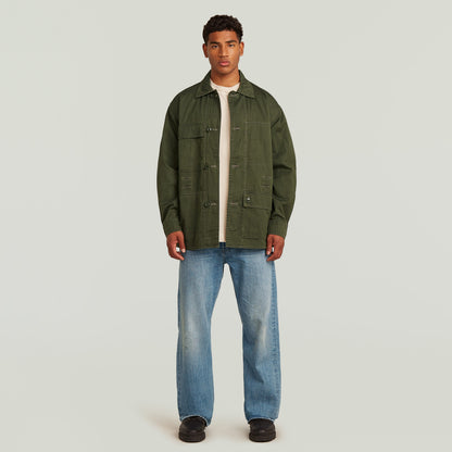 Reversible overshirt for versatile style, modern oversize fit in multi-color, 100% cotton, button closure, model wearing.