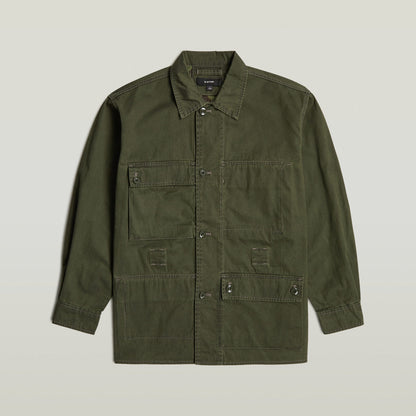Reversible overshirt for versatile style in olive green with button closure and multiple pockets, made of 100% cotton.