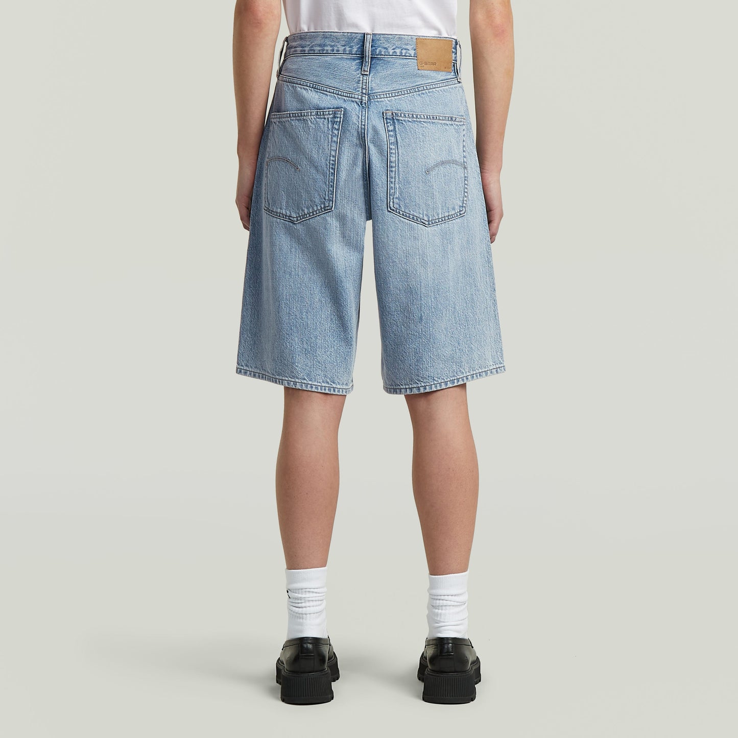 Bermuda shorts clean edge showing the back view with wide fit and knee-length cut.