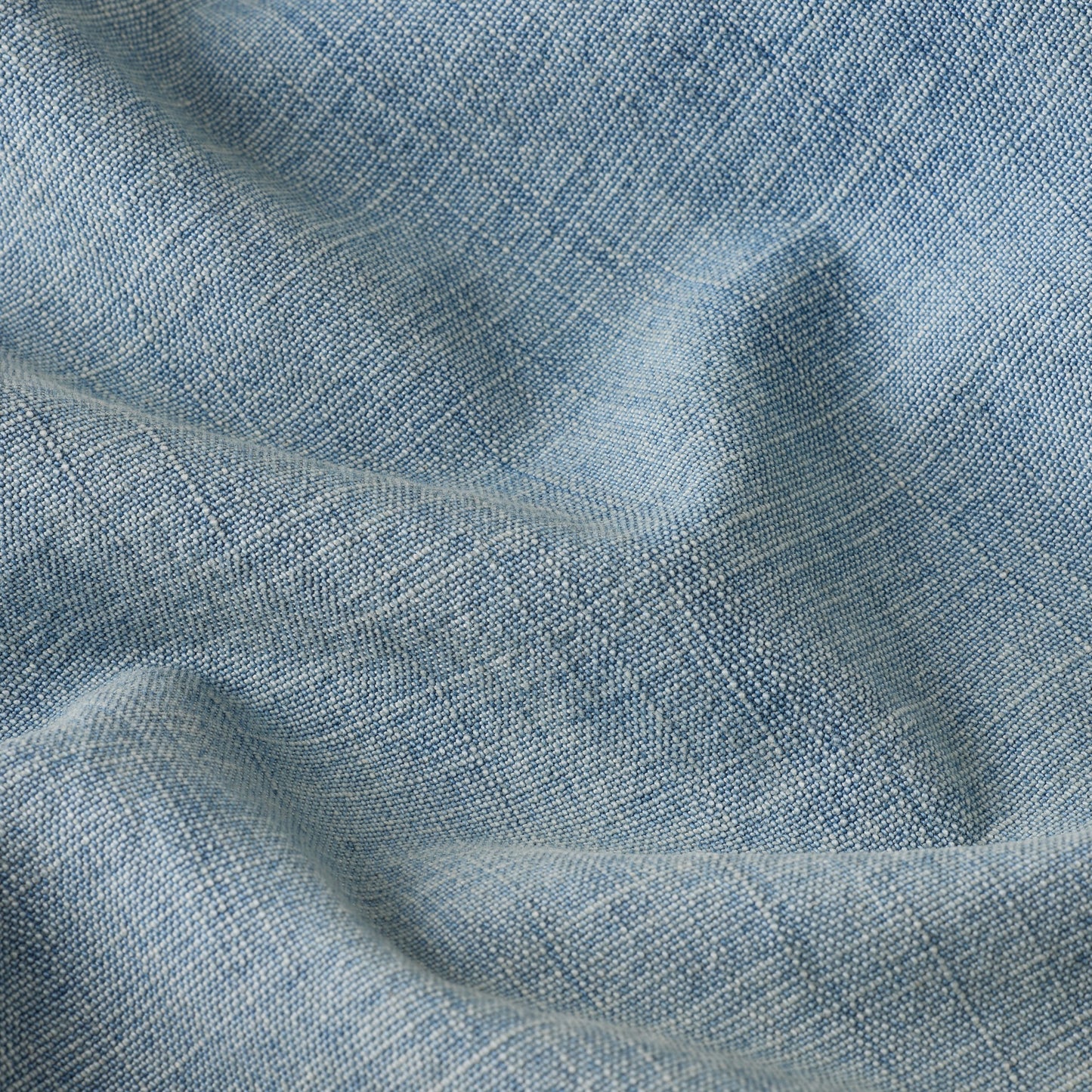 Close-up of fabric texture used in wide leg low rise jeans, showcasing a light blue color and woven pattern.