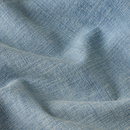 Close-up of fabric texture used in wide leg low rise jeans, showcasing a light blue color and woven pattern.