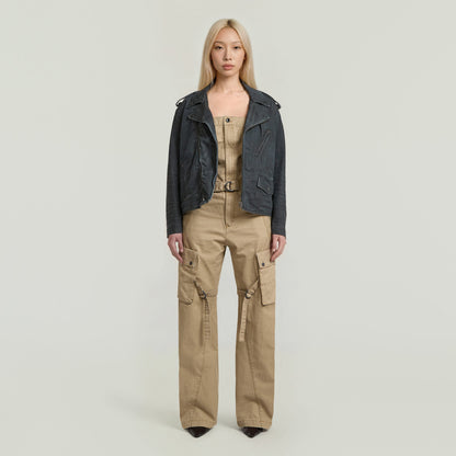 Model wearing a stylish Peto alto Elevated dungaree jumpsuit with a racerback design and a leather jacket.