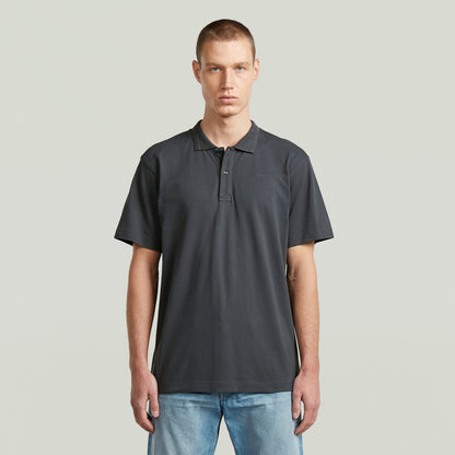 Model wearing the polo core regular shirt in gray, featuring a classic collar and button closure.