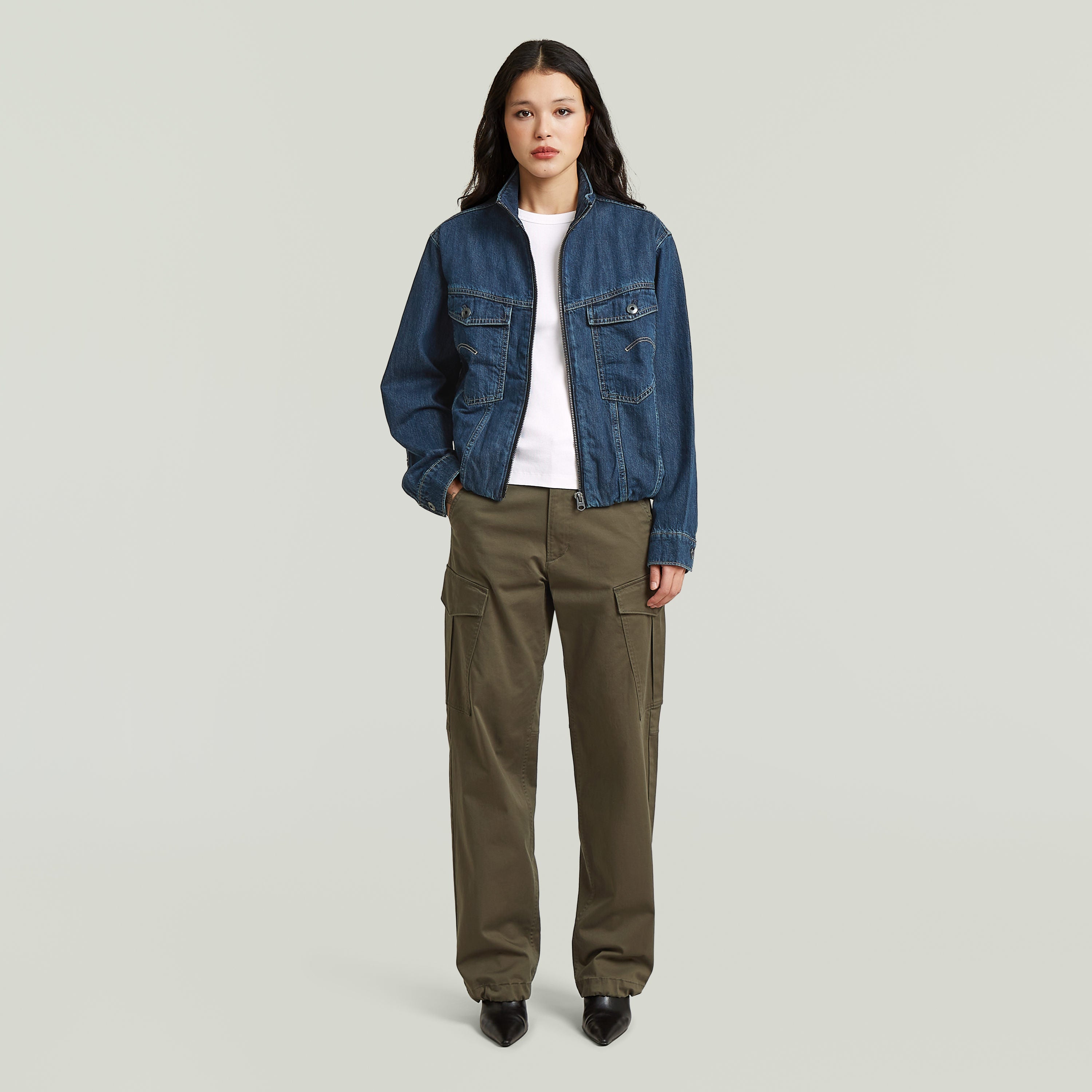Sustainable oversized trucker jacket worn by a model with cargo pants, showcasing a stylish and modern workwear look.