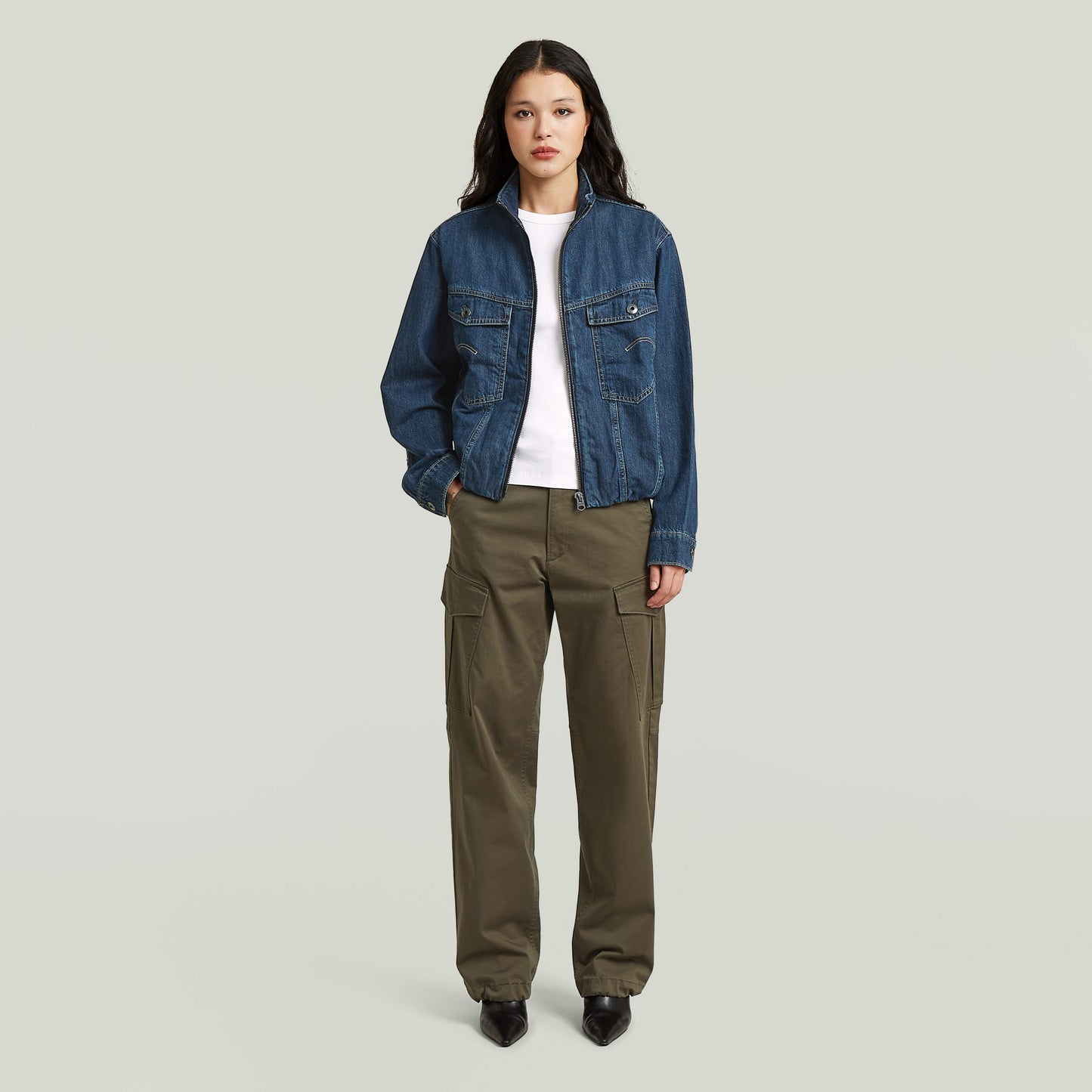 Sustainable oversized trucker jacket worn by a model with cargo pants, showcasing a stylish and modern workwear look.
