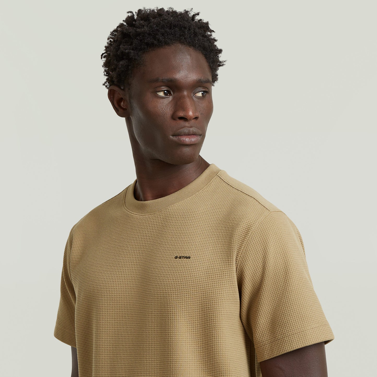 Waffle True Regular T-Shirt worn by a model, showcasing a regular fit waffle t-shirt in beige with a round neck.