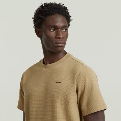 Waffle True Regular T-Shirt worn by a model, showcasing a regular fit waffle t-shirt in beige with a round neck.