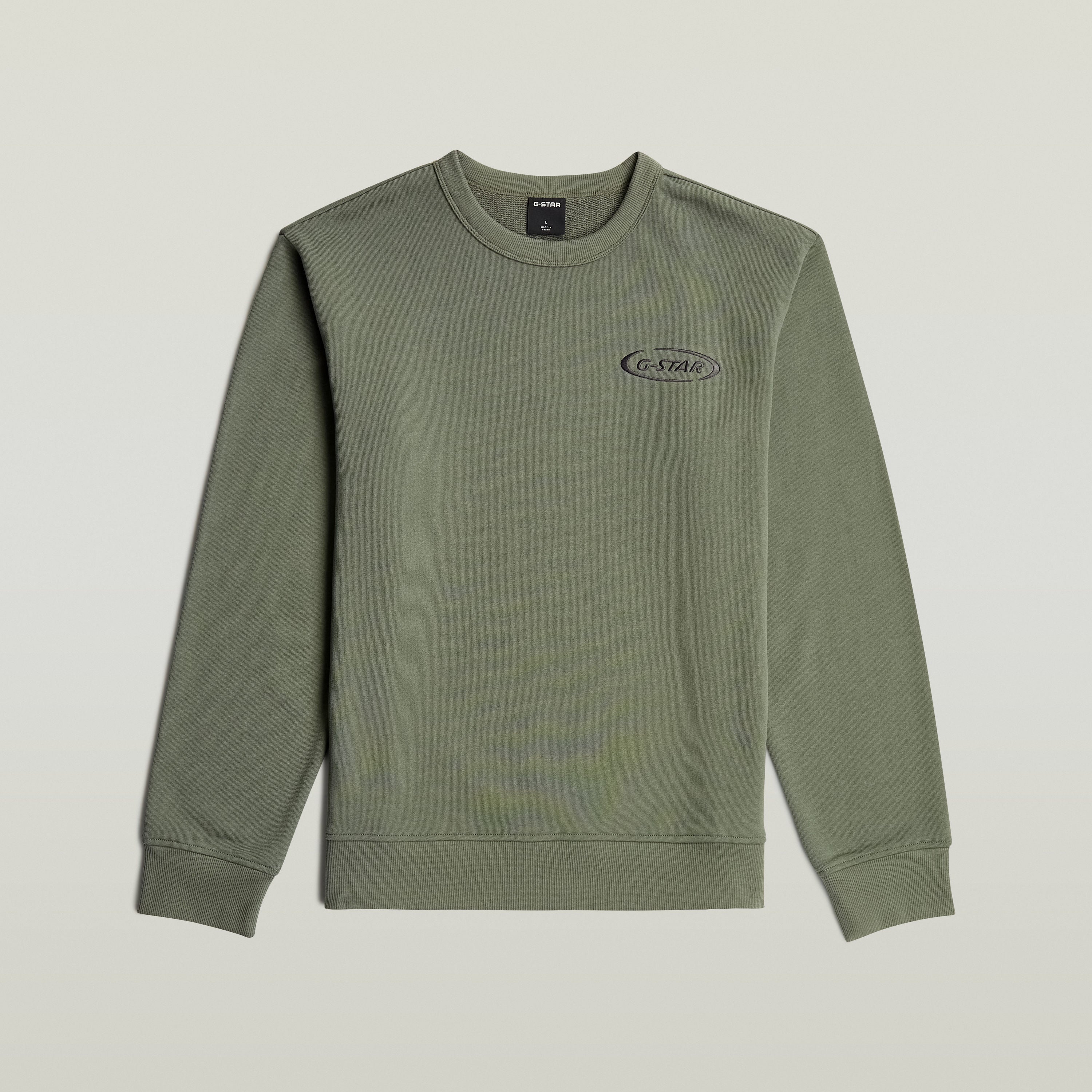 Sudadera con logotipo de los 90 en color verde, cuello redondo y diseño gráfico en el pecho.
