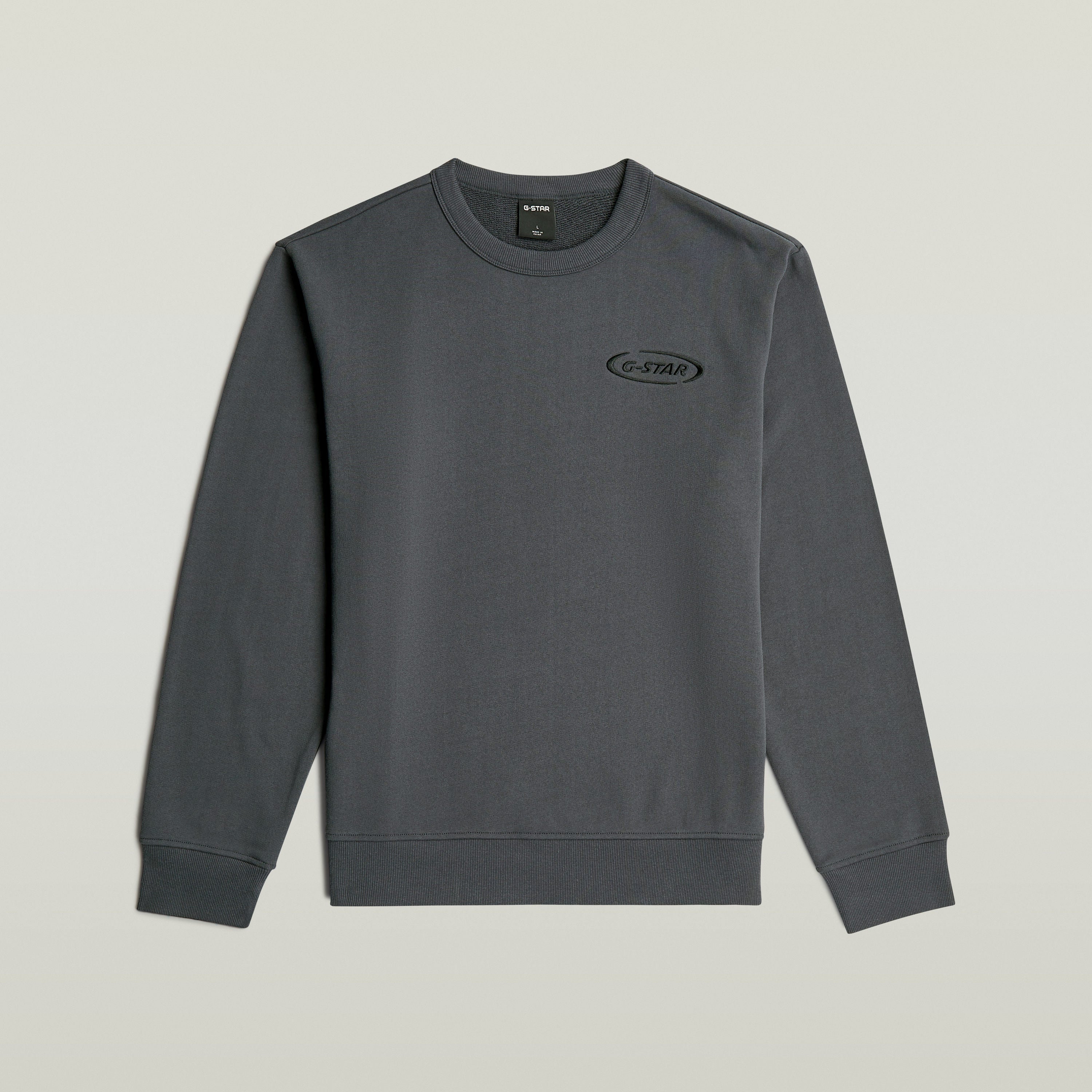 Sudadera con logotipo de los 90 en color gris con corte regular y cuello redondo.