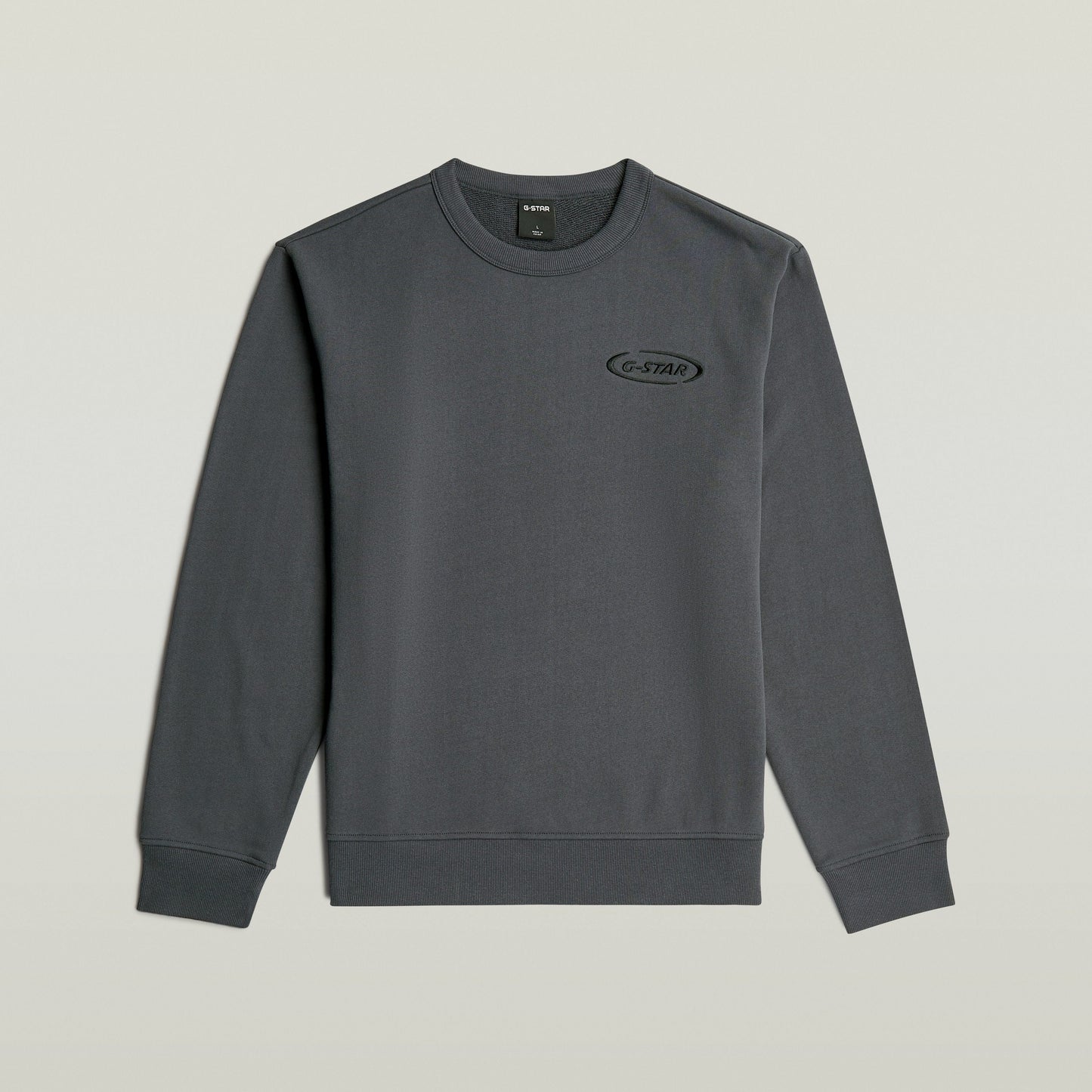 Sudadera con logotipo de los 90 en color gris con corte regular y cuello redondo.