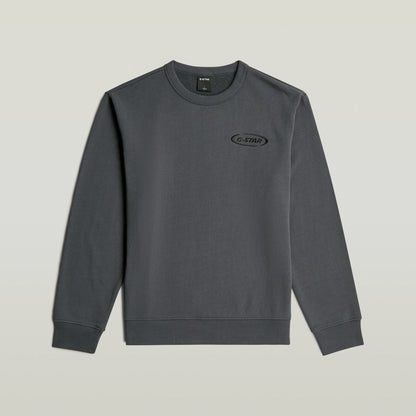 Sudadera con logotipo de los 90 en color gris con corte regular y cuello redondo.