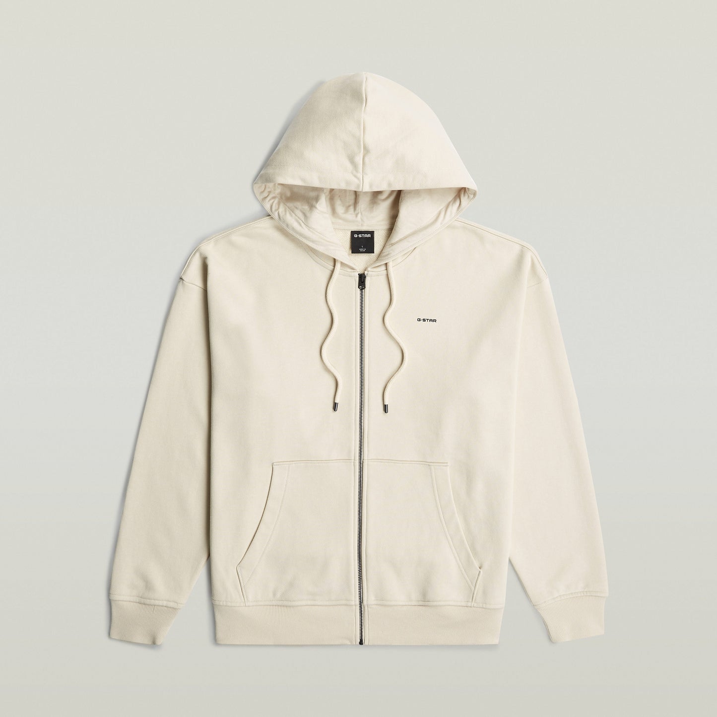 Sudadera Back Graphic Loose con Capucha y Cremallera El Back Graphic Loose Hooded Zip Sweater tiene fit holgado con capucha y cierre de cremallera, para un estilo relajado y casual.