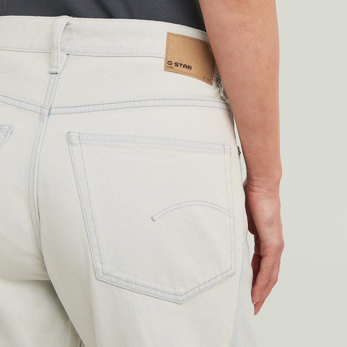 Close-up of G-STAR two-tone wide jeans showing back pockets and label detail.