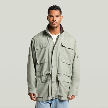 Versatile field smock jacket in green, featuring multiple pockets and a structured design, perfect for various occasions.