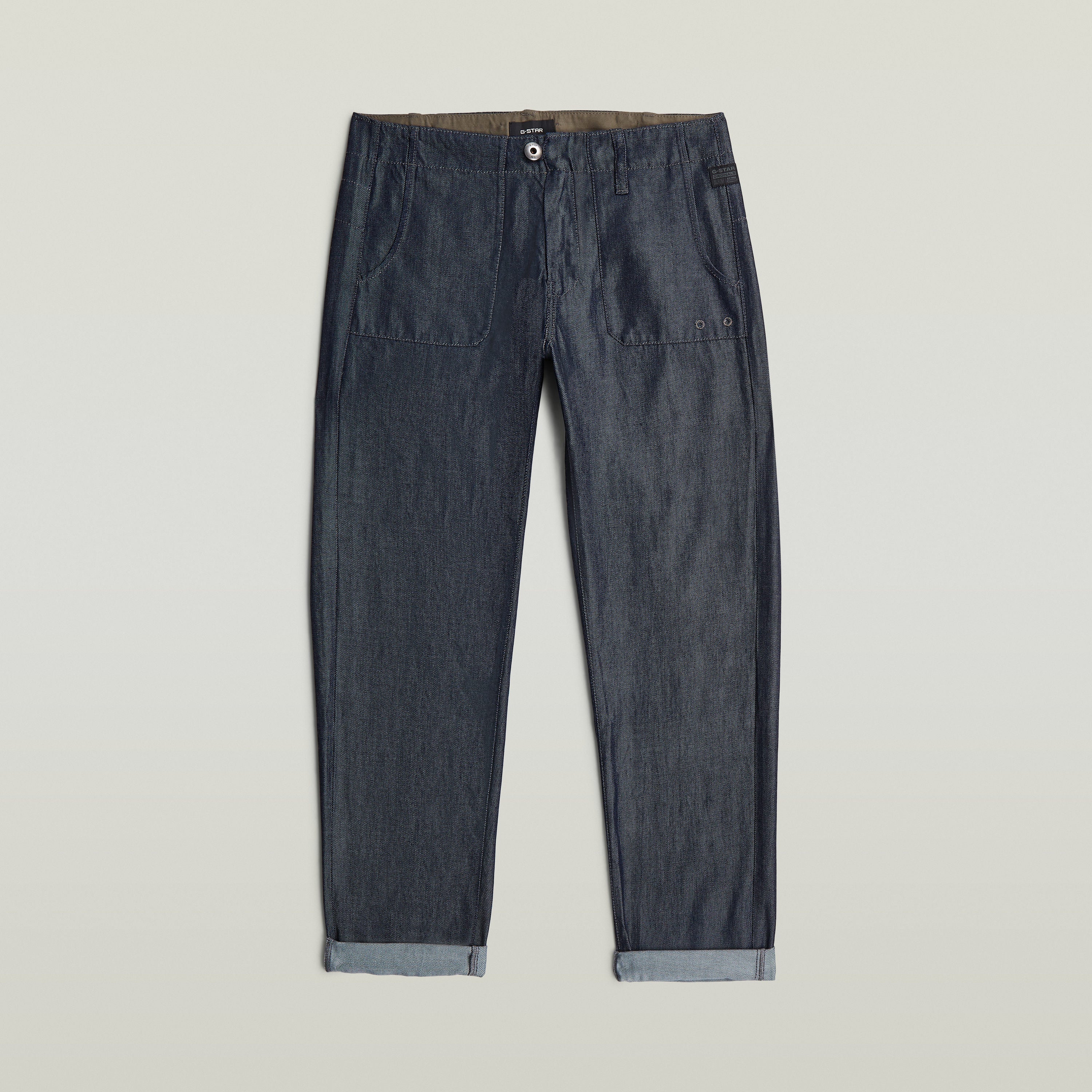 Pantalones Fatigue Boyfriend ligeros de denim oscuro con corte holgado y bolsillos delanteros.