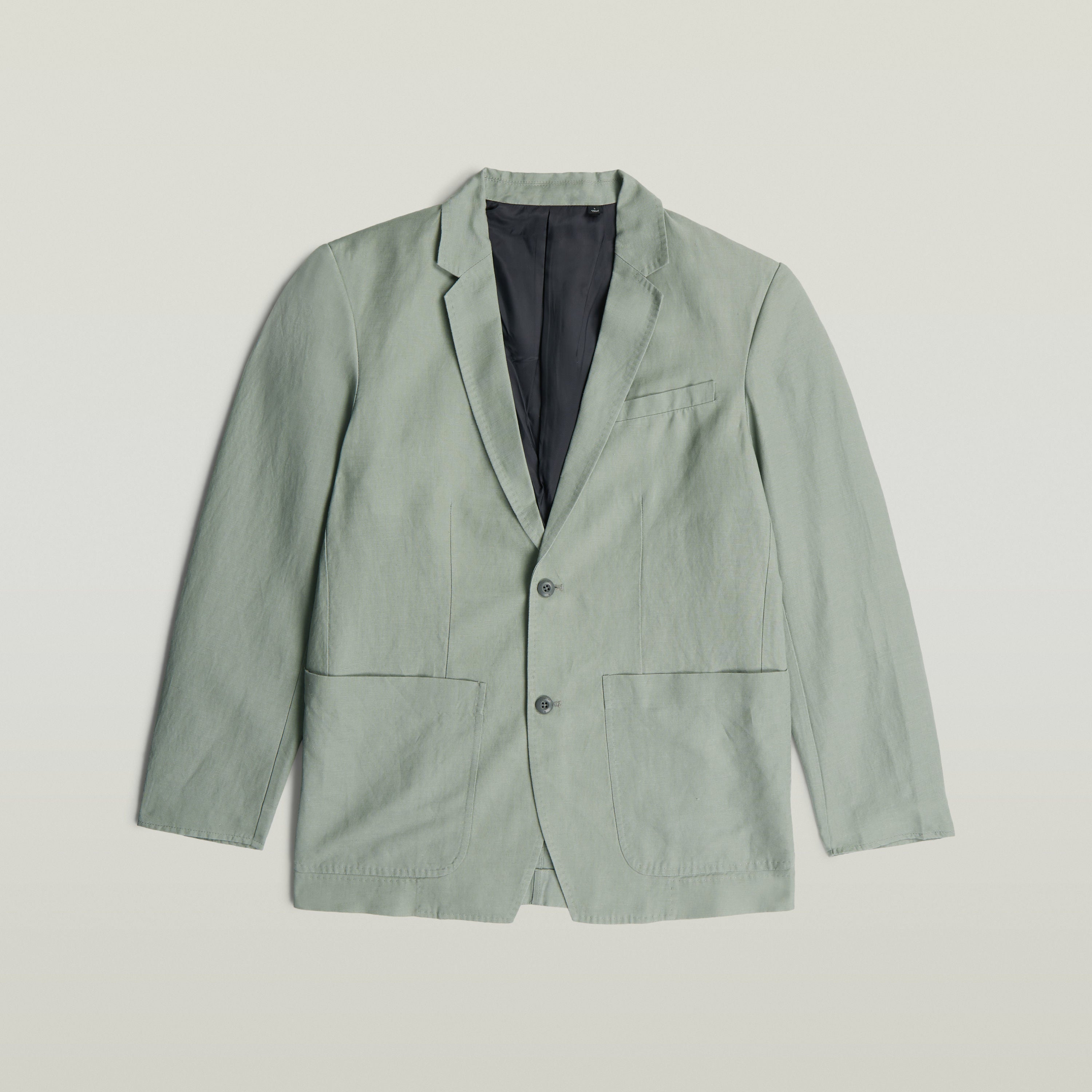 lightweight green blazer in classic design with notch lapel and button closure.