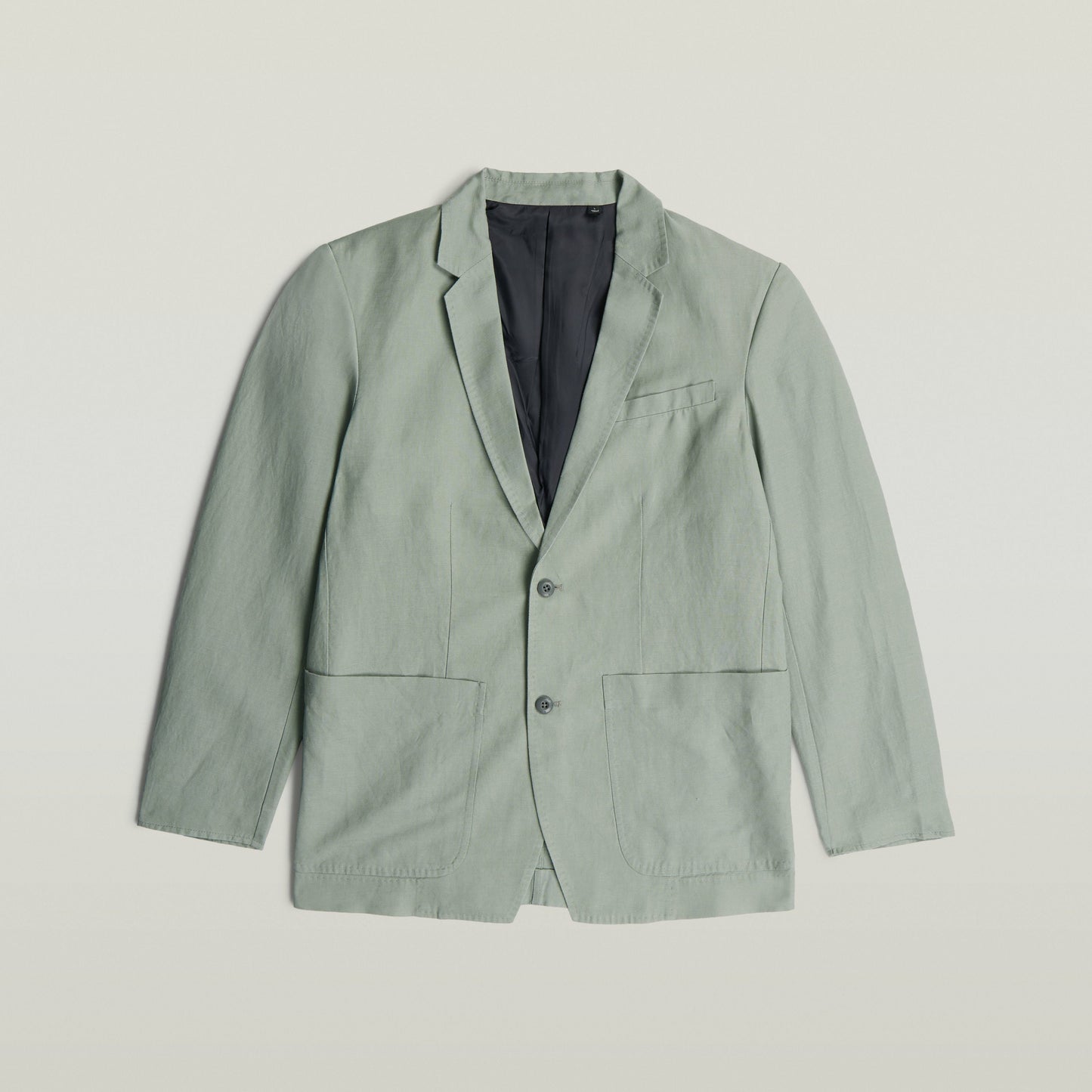 lightweight green blazer in classic design with notch lapel and button closure.