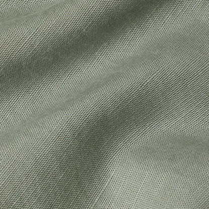 Summer chino pants fabric in a soft light green color, showcasing the lightweight and breathable material.