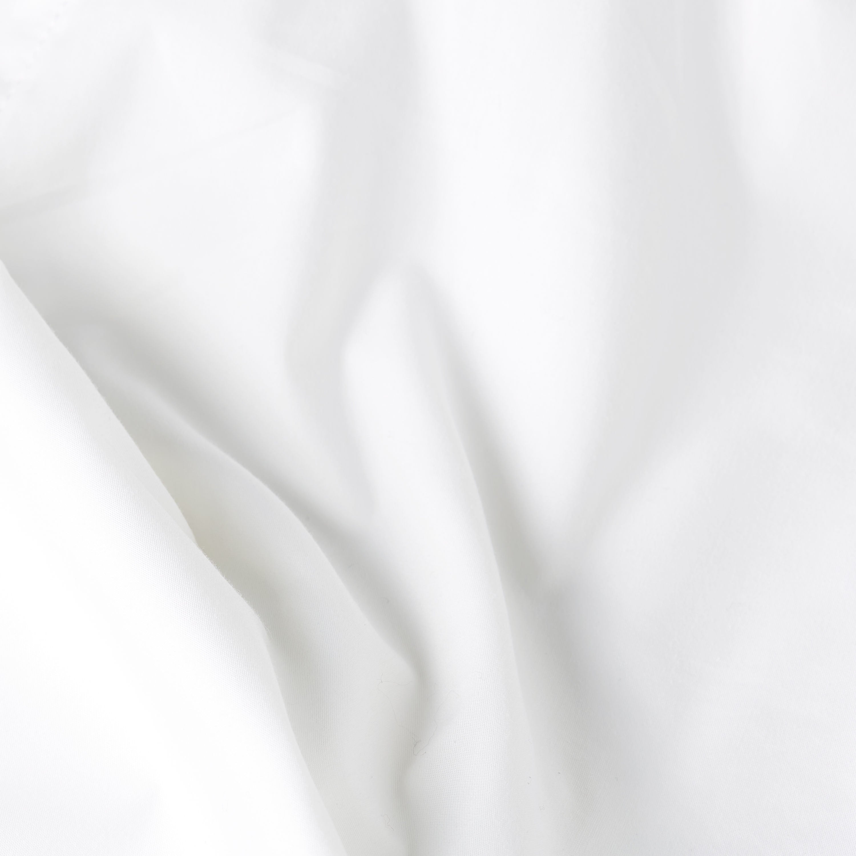 White fabric texture of the white bomber shirt, showcasing its premium material quality and elegance.