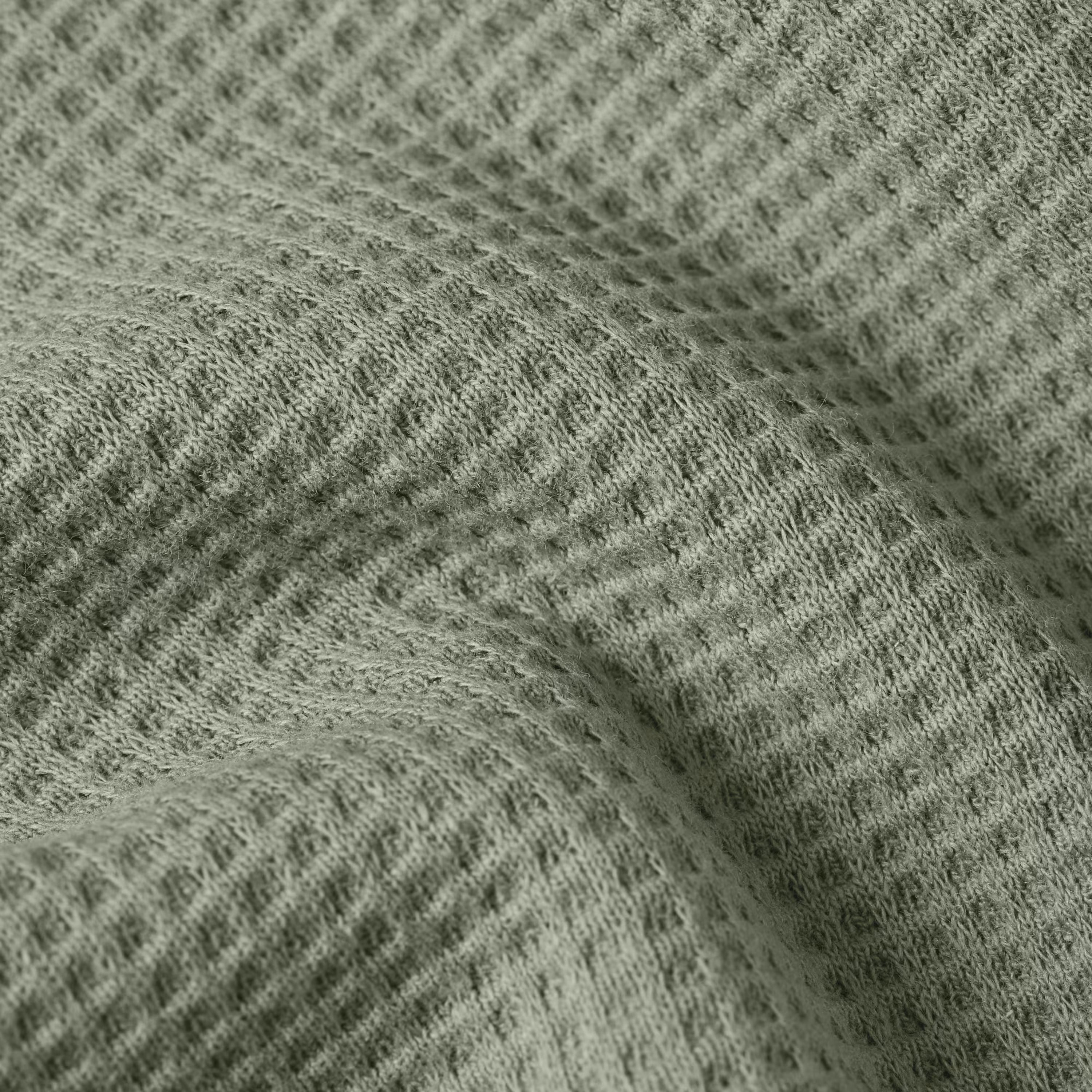 Textured fabric of a green textured relaxed t-shirt showcasing its unique surface design.