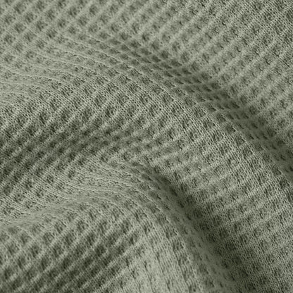 Textured fabric of a green textured relaxed t-shirt showcasing its unique surface design.