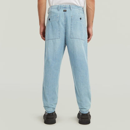 Denim relaxed tapered chinos showing back view with patch pockets and tailored fit.