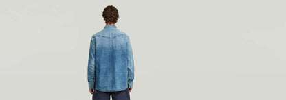 Camisa Dakota Regular vista trasera, diseño de corte recto en denim, bajo redondeado, 100% algodón.