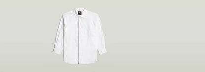 Camisa extragrande de popelín con cremallera en color blanco, con cierre de botón y cremallera, diseño moderno.