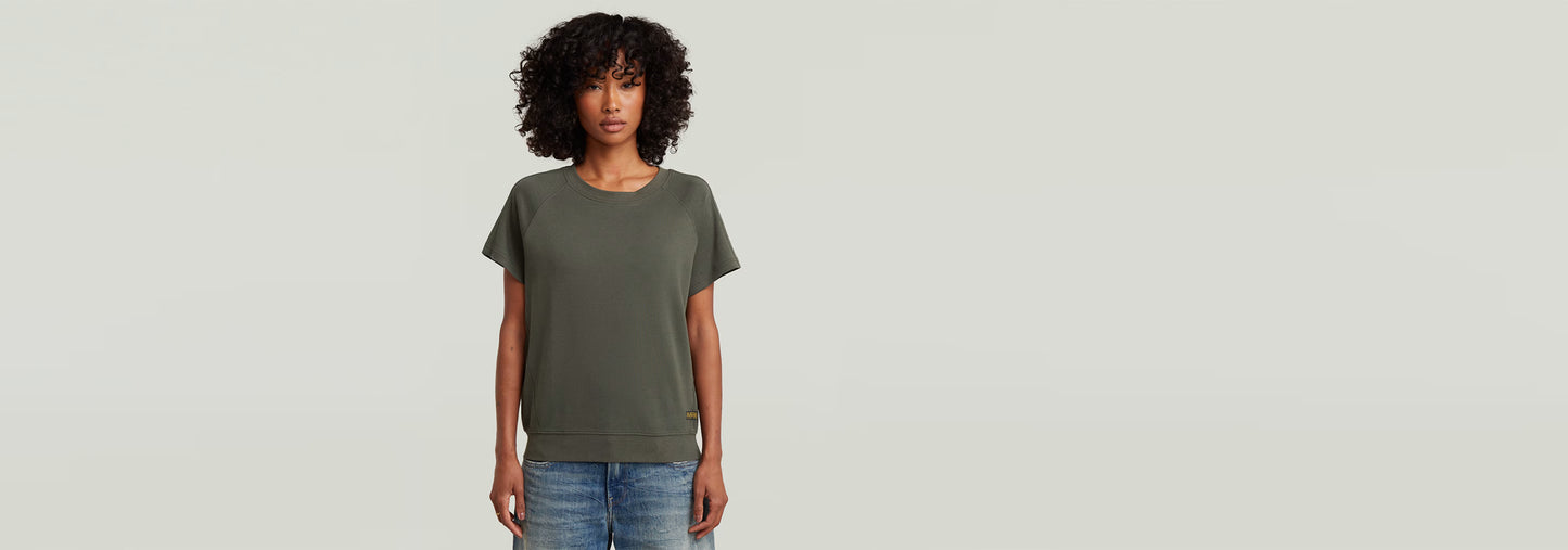Camiseta Raglan de corte recto, manga de casquillo y cuello redondo, 100% algodón ecológico.