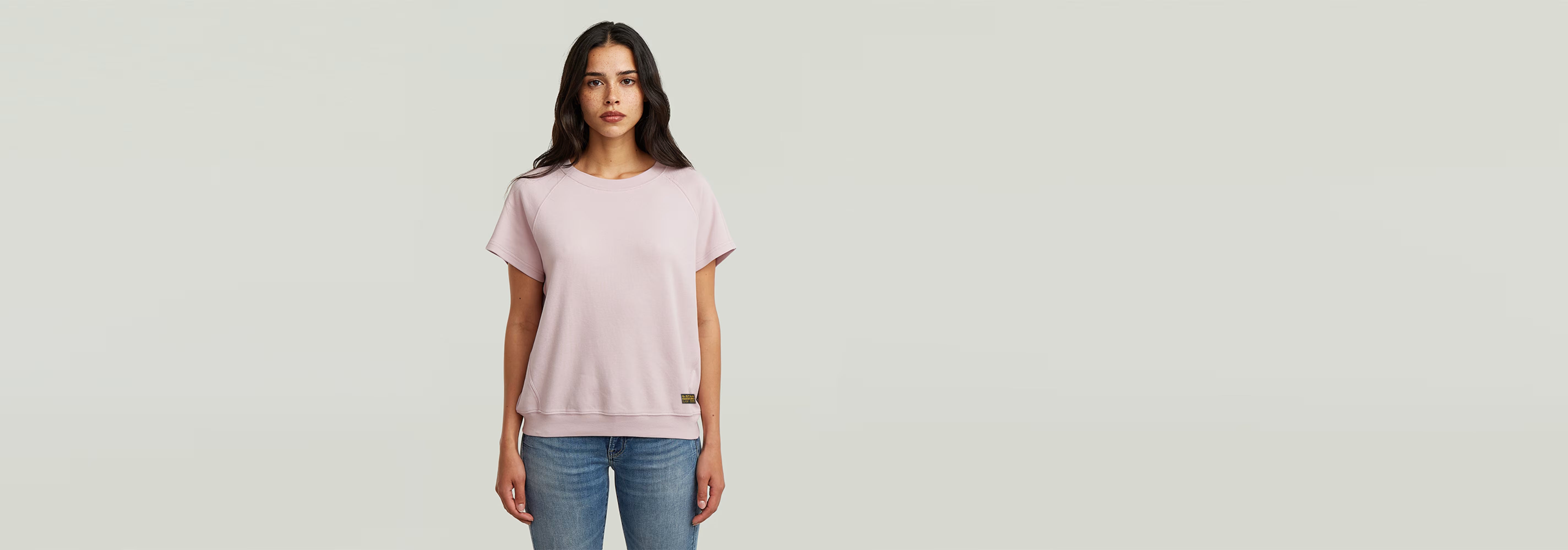 Camiseta Raglan de color rosa, con corte recto, mangas de casquillo y cuello redondo en 100% algodón ecológico.