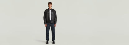 Hombre modelando la Chaqueta Biker Leather con cuello alzado y cierre de cremallera, en fondo neutro.