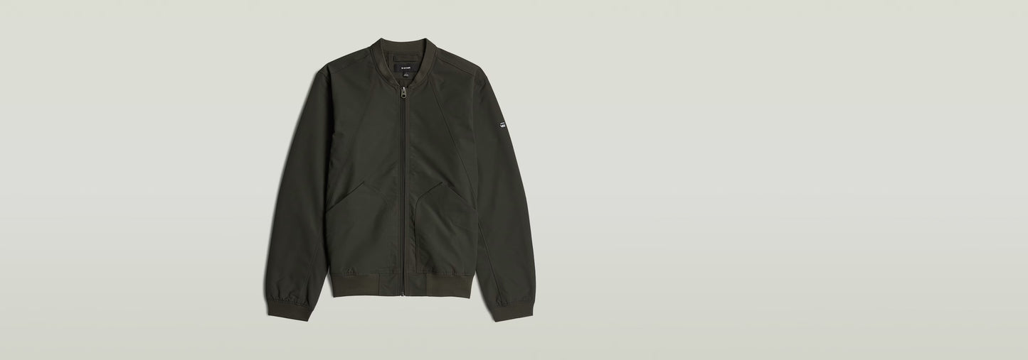 Chaqueta Bomber Unpadded en color verde oscuro con cierre de cremallera y corte recto.