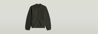 Chaqueta Bomber Unpadded en color verde oscuro con cierre de cremallera y corte recto.