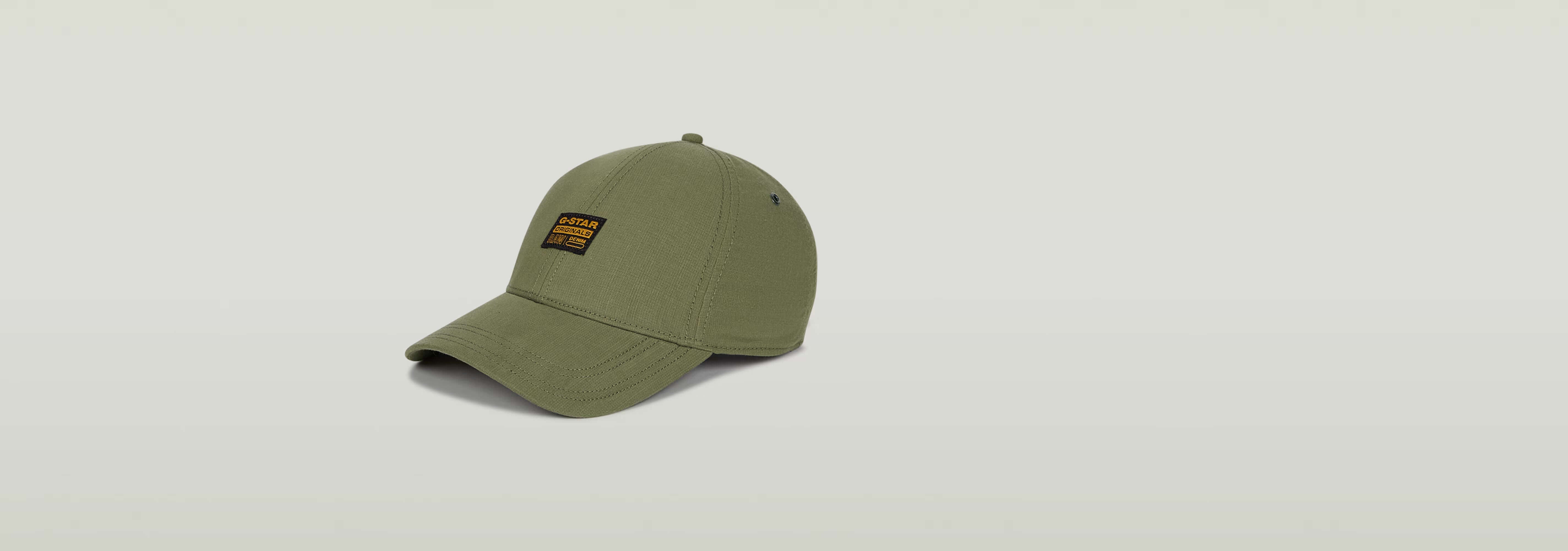 Gorra Originals Baseball color oliva con visera curvada y etiqueta G-STAR Originals en la parte delantera.